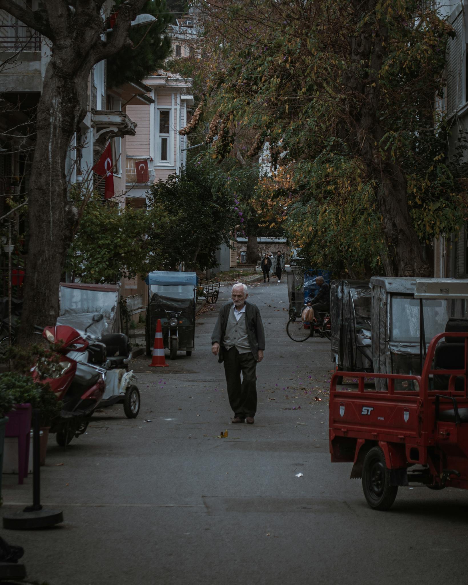 A serene street scene in Istanbul with an elderly man walking, showcasing Turkey's urban life.